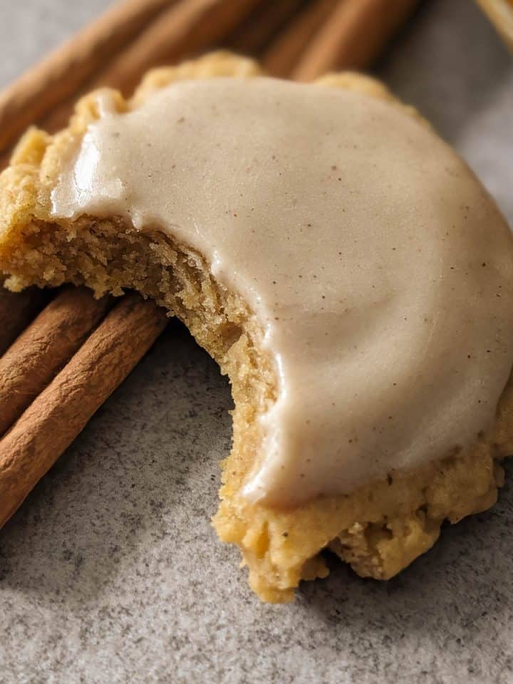 Close up of a soft pumpkin cookie with a bite missing.
